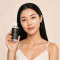 glycolic-acid-exfoliating-toner held by model